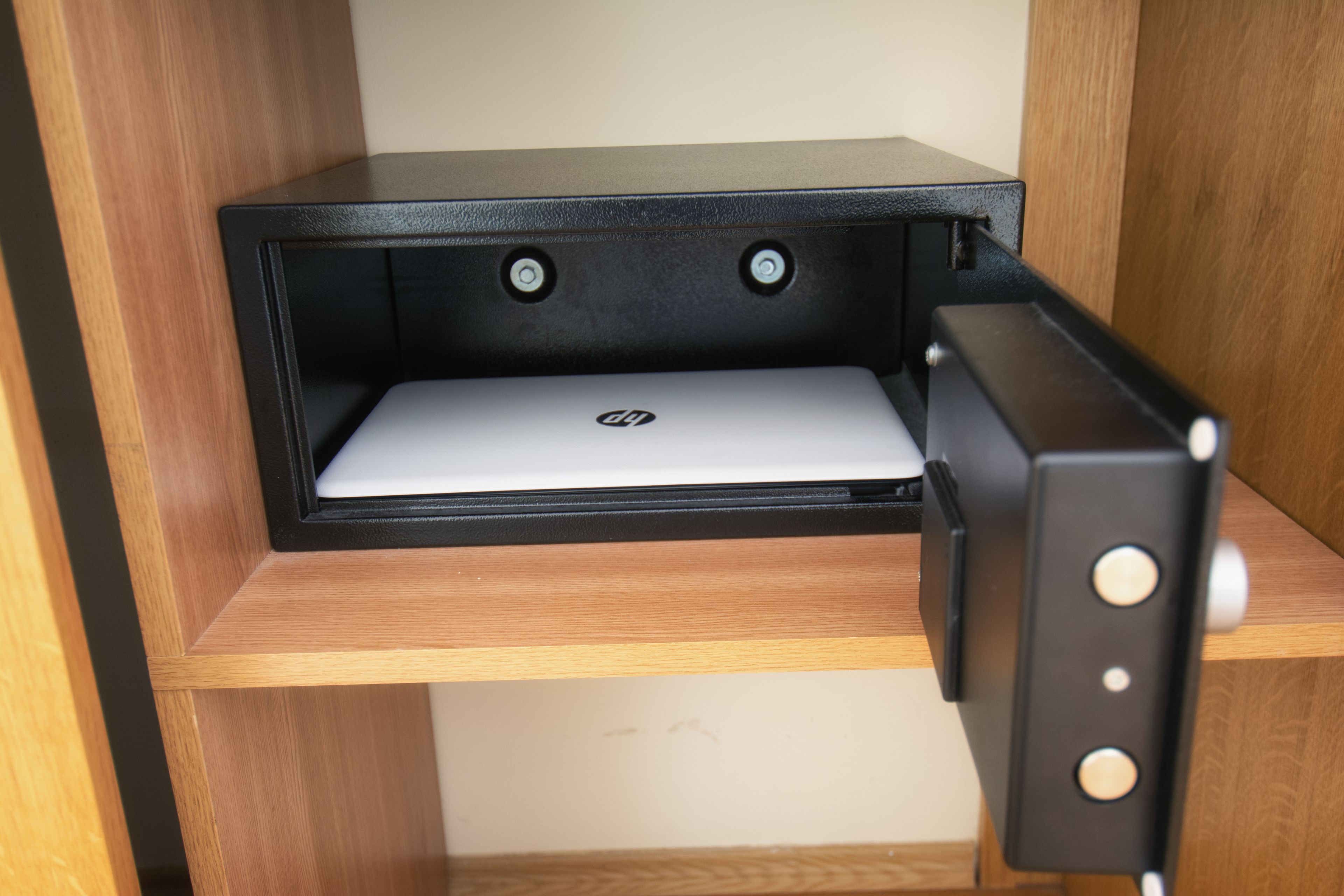 A laptop on a shelf with a black frame.