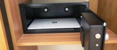 A laptop on a shelf with a black frame.