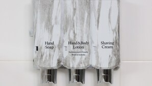 A hand soap dispenser, a hand and body lotion dispenser, and a shaving cream dispenser.