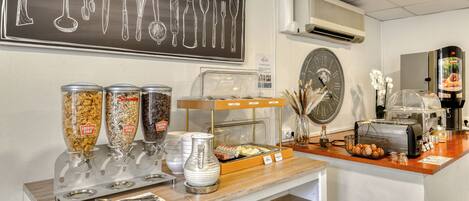 A breakfast bar with food dispensers, a clock, and a coffee machine.