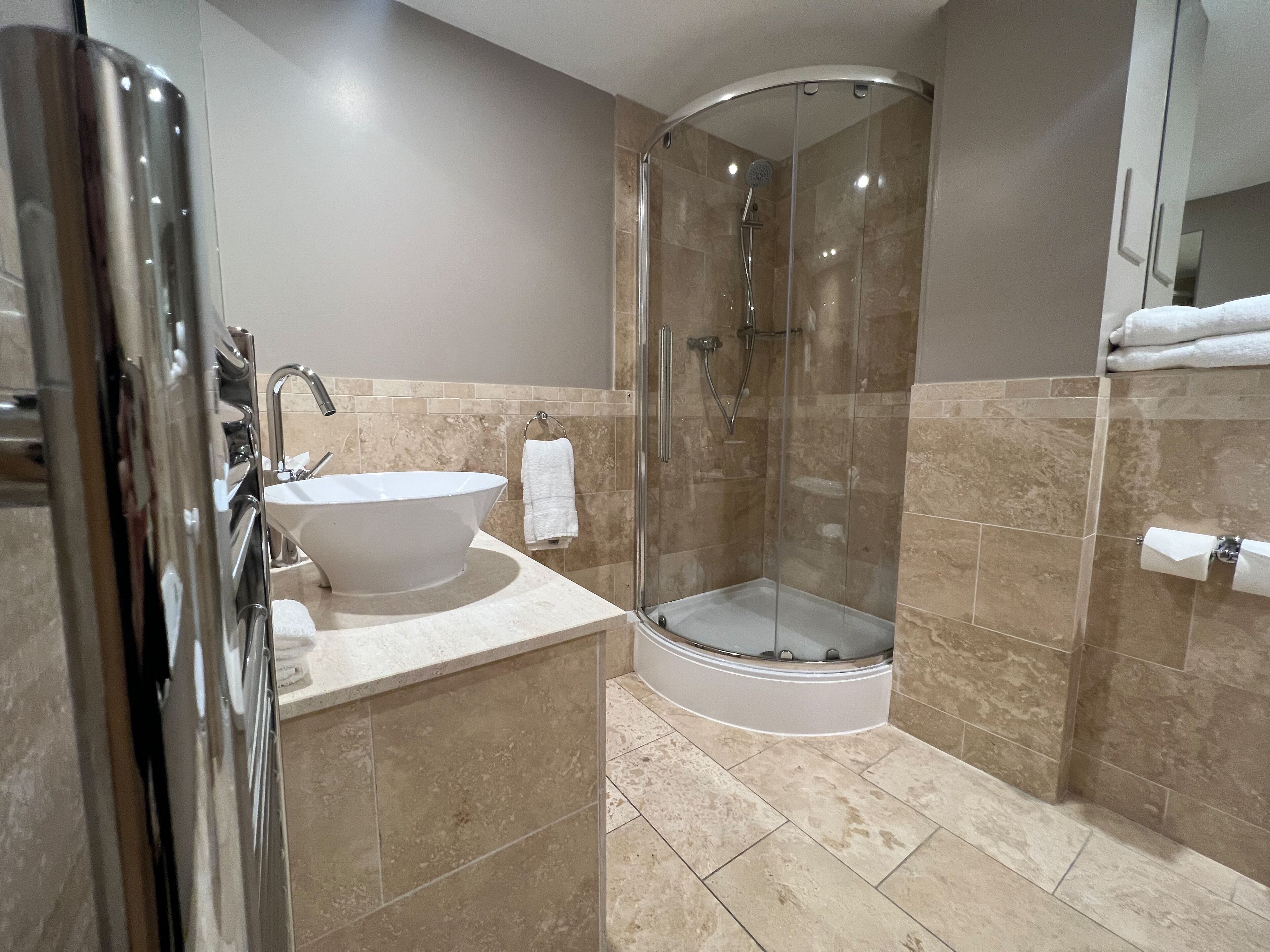 family room, 1 king bed (daytime pitch view) | bathroom | designer toiletries, hair dryer, towels