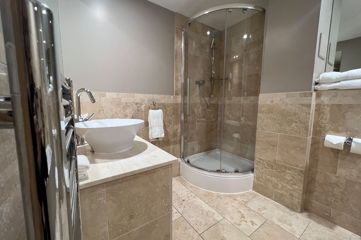 family room, 1 king bed (daytime pitch view) | bathroom | designer toiletries, hair dryer, towels