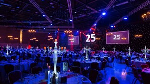 A banquet hall with round tables, numbered chairs, and illuminated chandeliers. - DoubleTree by Hilton Milton Keynes (Milton Keynes)