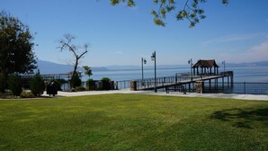 A waterfront park with a gazebo, a walking path, and a view of the water.