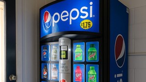 A blue Pepsi vending machine with various drink options. - Paragon Inn Hillsboro (Hillsboro)