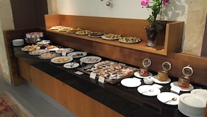A buffet with various food items and condiments.