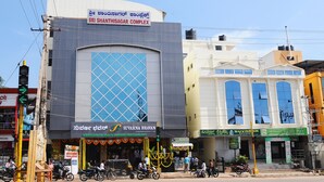 A multi-story building with a sign for 'Sri Shanthisagar Complex'.