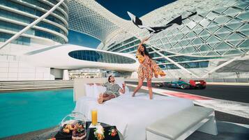 Experience the hotel's unique architecture and enjoy a luxurious poolside setting with a comfortable bed and stunning views.