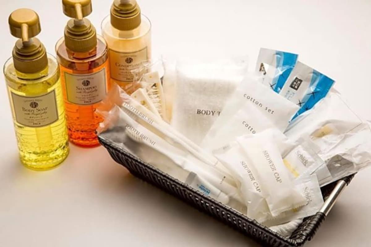 A basket containing various toiletries including bottles and packets, likely for hotel guests.
