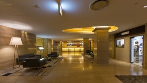 A spacious lobby with a reception desk, seating area, and a large window. - Shibuya Tobu Hotel (Tokyo)