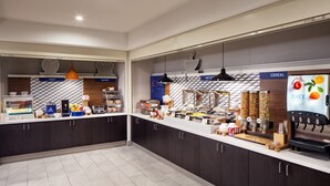A modern kitchen area with a counter displaying various food items and a juice dispenser. - Holiday Inn Express & Suites Los Alamos Entrada Park by IHG (Los Alamos)