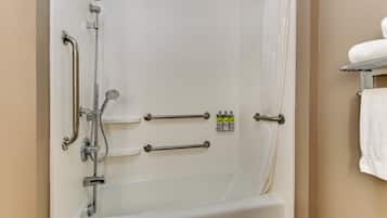 A bathroom with a bathtub, grab bars, a showerhead, and a towel rack.