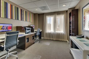 A hotel room with a desk, chair, computer, telephone, and a window with curtains. - Holiday Inn Express & Suites Columbus – Fort Benning Maingate by IHG (Columbus)