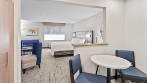 A hotel room with a bed, a desk, a chair, a small table, and a sofa. - Holiday Inn Express Hotel & Suites Mount Airy by IHG (Mount Airy)