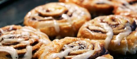 Freshly baked cinnamon rolls are served in a warm and inviting display.