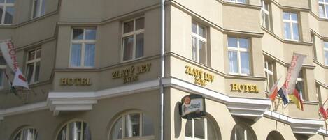 A multi-story hotel with a classic architectural style, featuring arched windows and a prominent entrance.