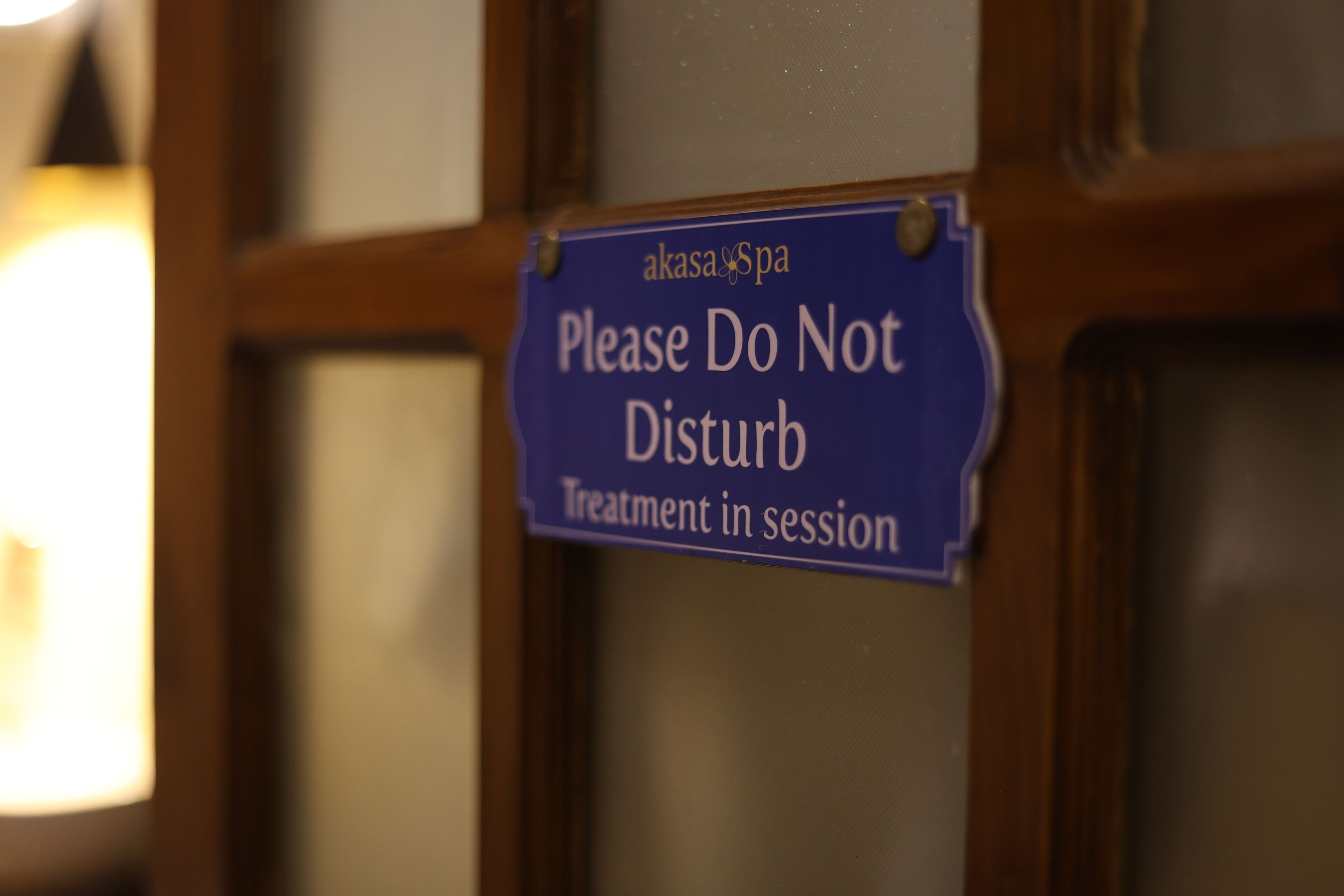 A sign on a door that reads "Please Do Not Disturb Treatment in session."