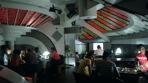 A modern interior with curved ceilings and LED displays. - Hotel Supreme (Madurai)