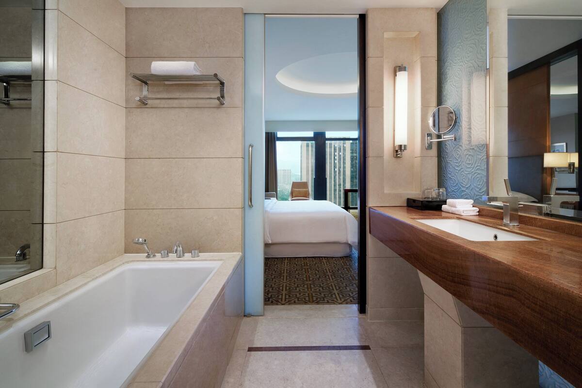 separate bathtub and shower, rainfall showerhead, designer toiletries