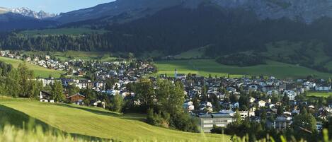 A town nestled in a valley with a prominent mountain in the background.