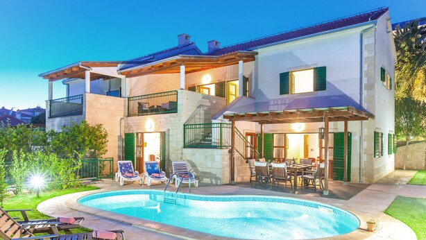 A two-story house with a swimming pool, outdoor seating, and a well-maintained garden. - Villa Dane (Hvar)