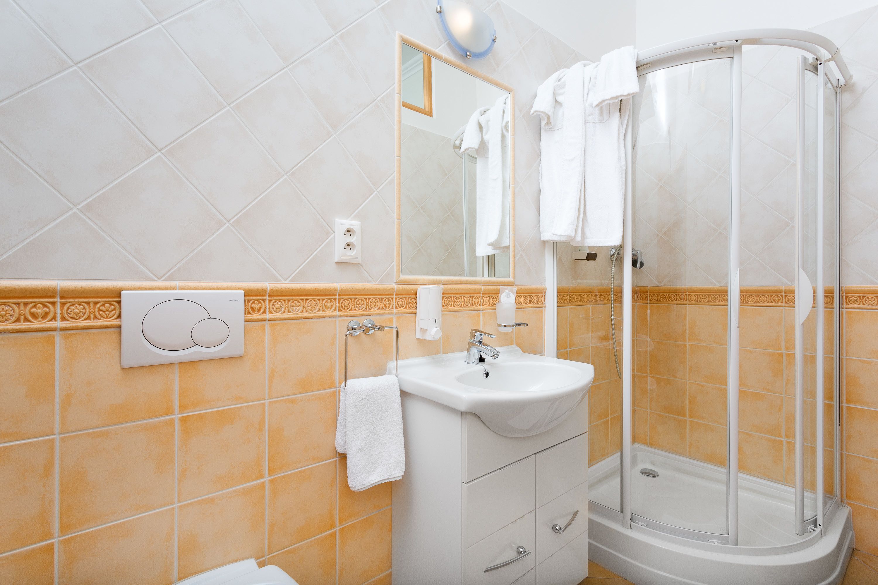 A bathroom with a shower, sink, and mirror.