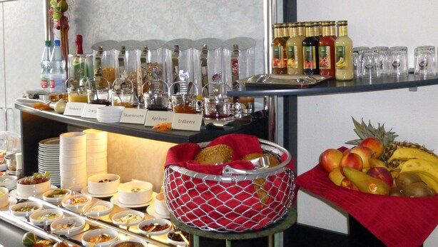 A buffet setup with various food items and condiments. - Altstadthotel An Der Werra (Meiningen)