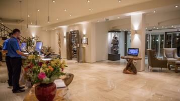 A spacious lobby with a reception desk, computers, and seating areas.