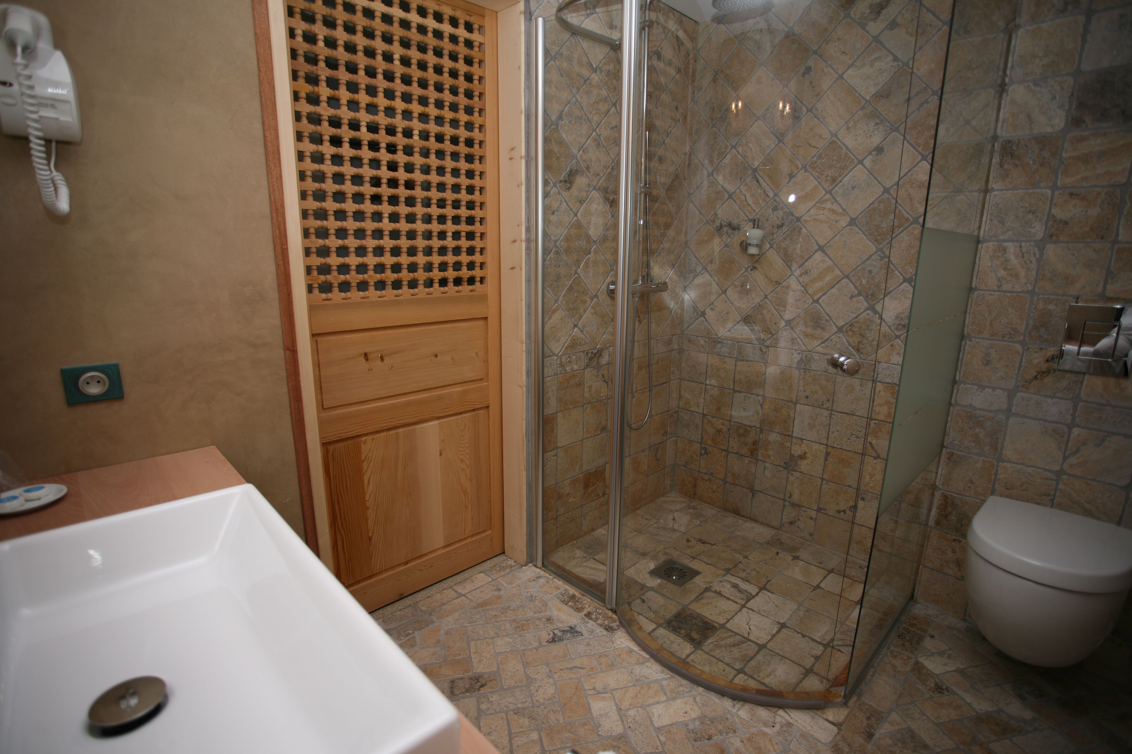 A bathroom with a shower, toilet, and sink.
