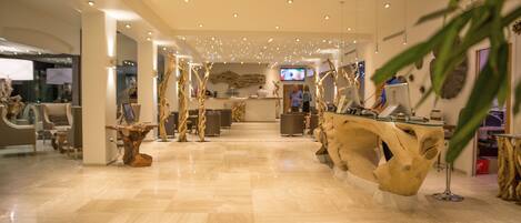 A modern interior with a central reception desk, seating area, and decorative wooden elements.