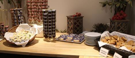 A buffet table with various food items and labeled containers.