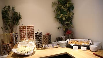 A buffet table with various food items and condiments.