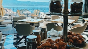 A breakfast buffet with croissants, coffee, and various condiments. - Hotel San Carlu Citadelle (Ajaccio)