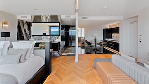 A modern hotel room with a large bed, a sofa, a dining area, and a kitchen. - Hotel San Carlu Citadelle (Ajaccio)
