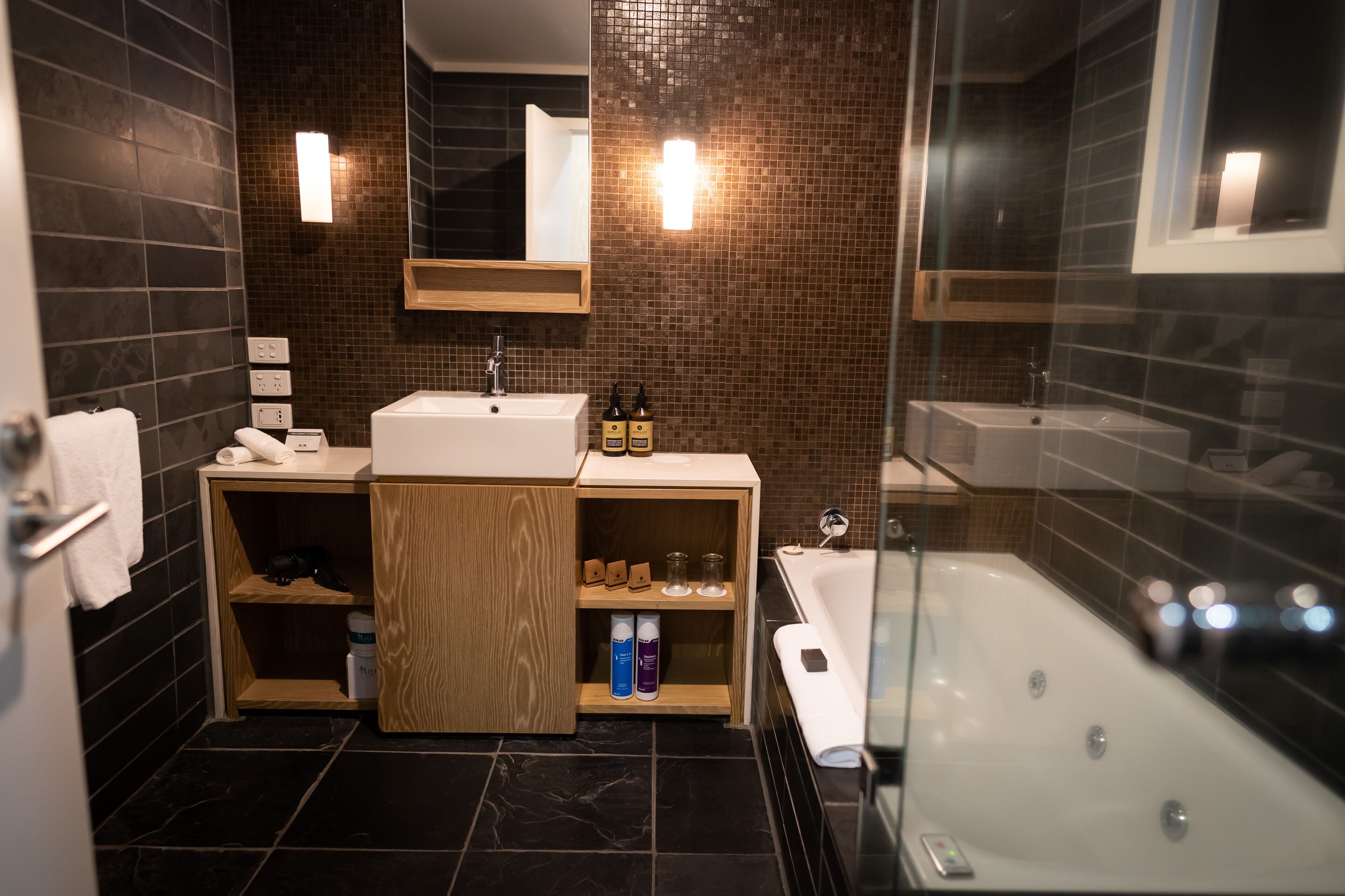 designer toiletries, hair dryer, towels, soap