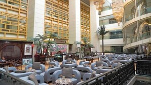 A spacious lobby with a high ceiling, modern furniture, and a central seating area. - Baotou Hotel State Guest Building (Baotou)