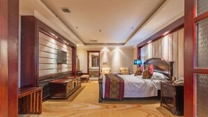 A hotel room with a bed, bedside tables, a TV, and a carpeted floor. - Baotou Hotel State Guest Building (Baotou)