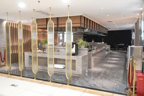A modern hotel lobby with a reception desk, a bar area, and a seating space. - Baotou Hotel State Guest Building (Baotou)