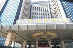 A modern building with a prominent entrance and large windows.
