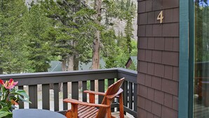 A wooden deck with a table and chairs, a mountain backdrop, and a house number 4. - Tamarack Lodge and Resort (Mammoth Lakes)