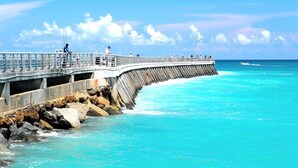 A pier extending into turquoise waters with a clear sky. - Holiday Inn Express & Suites Palm Bay by IHG (Palm Bay)