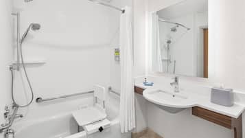 A modern bathroom with a bathtub, shower, and sink.