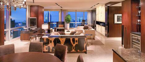 A modern living room with a city view, a dining area, and a kitchen.