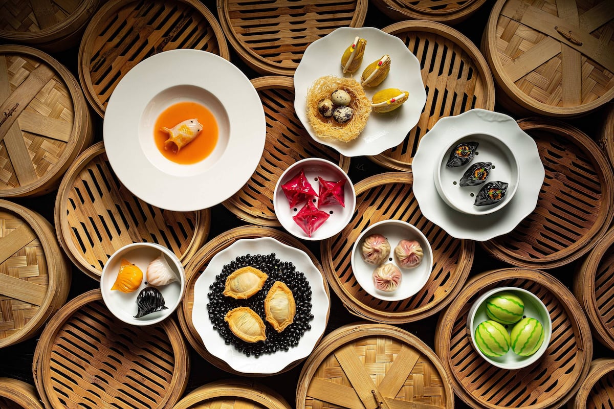 A variety of traditional dishes arranged on wooden chafing dishes.