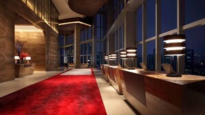 A modern hotel lobby with a red carpet, large windows, and contemporary lighting fixtures. - Grand Hyatt Shenzhen (Shenzhen)