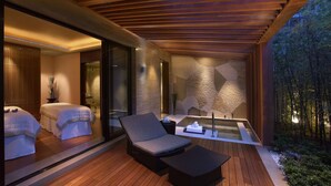 A modern spa area with wooden flooring, a glass-enclosed room, and a seating area with a hot tub. - Grand Hyatt Shenzhen (Shenzhen)