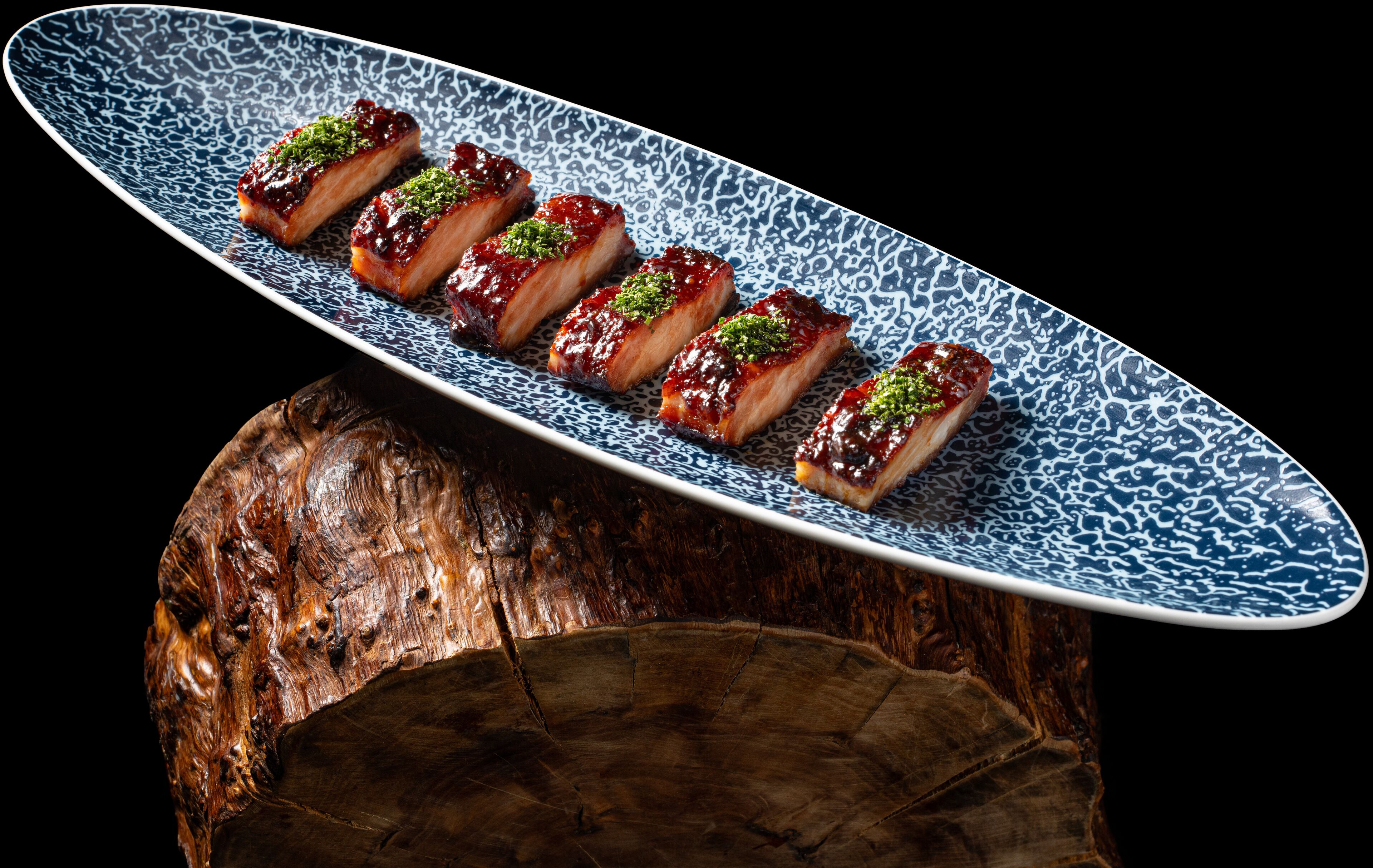 A plate of food with a blue pattern on a wooden surface.