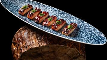 A plate of food with a blue pattern on a wooden surface.