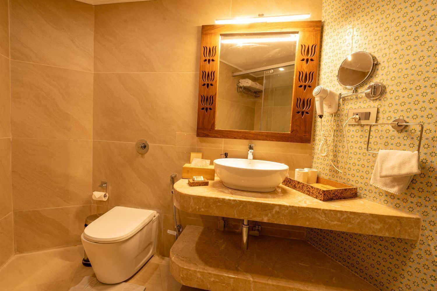 A bathroom with a toilet, sink, and shower.