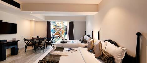 Una habitación de hotel moderna con una cama grande, un escritorio y una zona de comedor.
